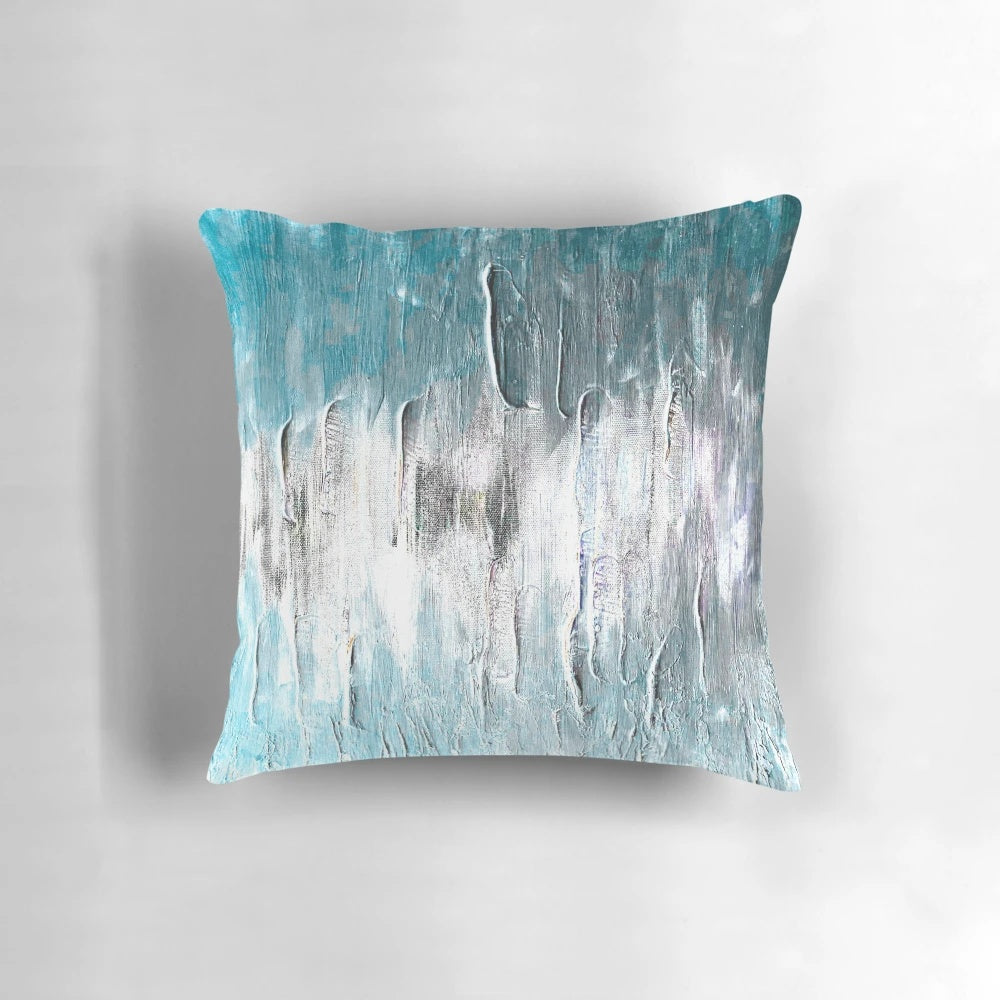 Teal and blue abstract waves design on a soft, modern throw pillow for coastal or minimalist home decor.