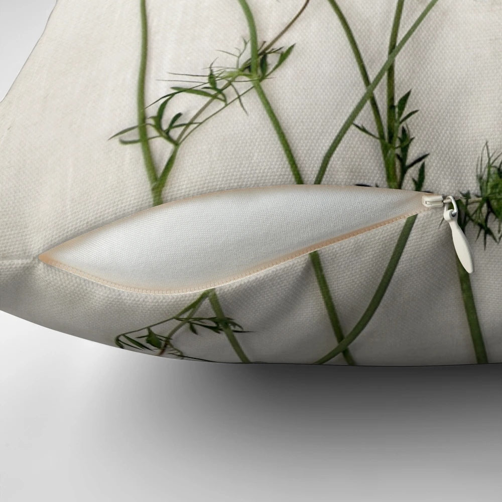 A beautiful Queen Anne's lace flower featured on a white and green minimalist pillow.