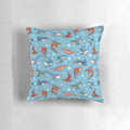 Decorative blue pillow featuring a vibrant pattern of various shark species swimming in the ocean.