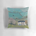 A pillow featuring a beautiful spring landscape with blooming daffodils and picturesque cottages in the countryside.
