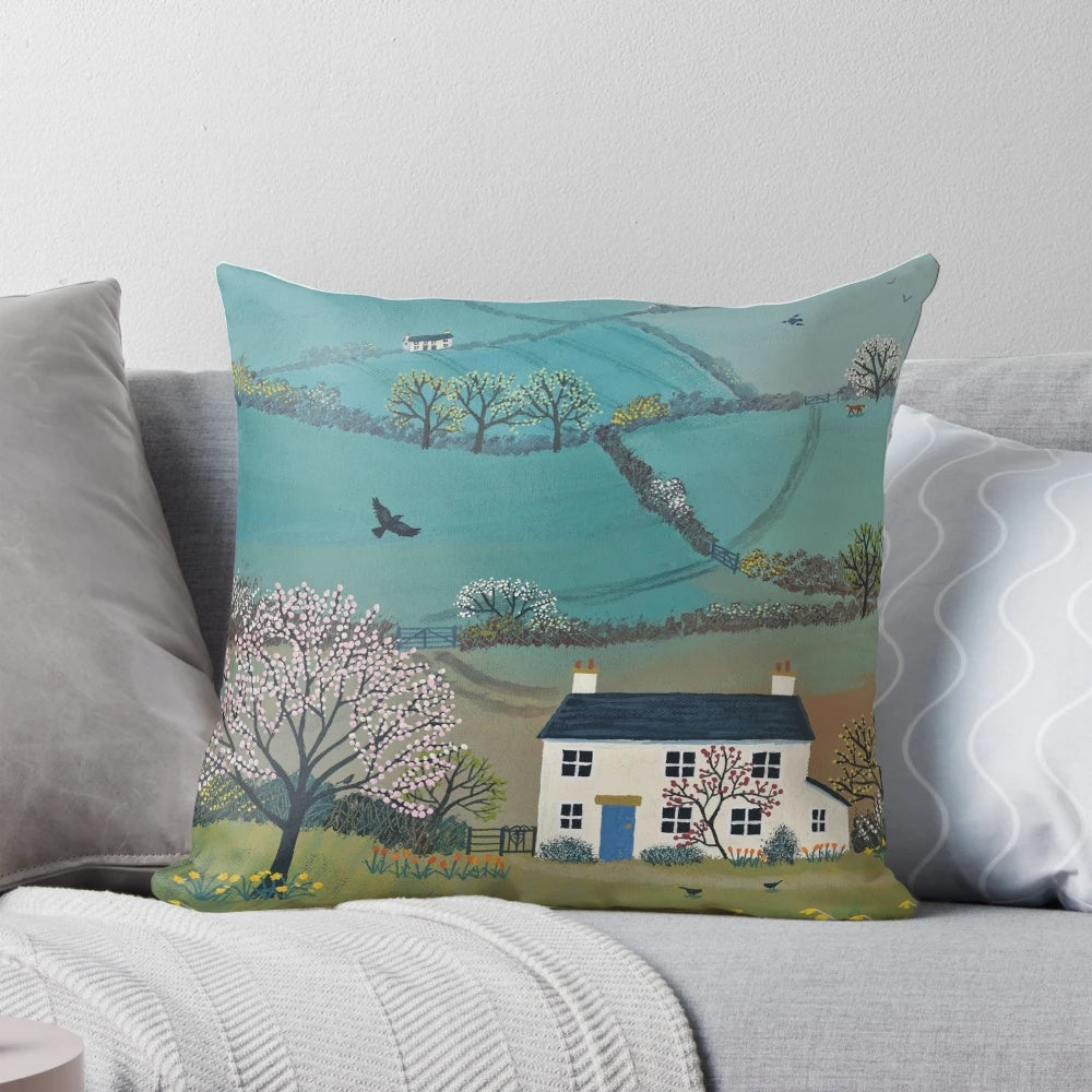 A pillow featuring a beautiful spring landscape with blooming daffodils and picturesque cottages in the countryside.