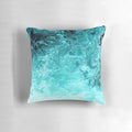 Turquoise pillow with a rippled wave pattern, inspired by the ocean