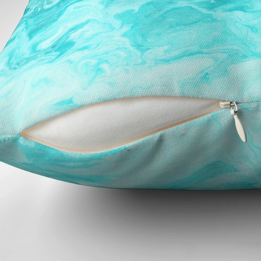 Turquoise pillow with a rippled wave pattern, inspired by the ocean