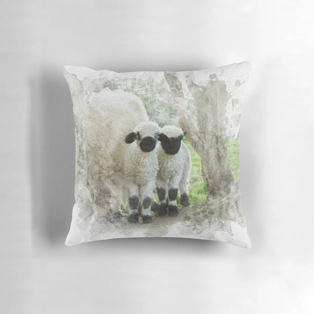 Watercolor painting of two adorable Valais Blacknose lambs on a farmhouse pillow