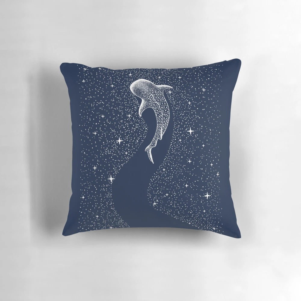 A photo of a pillow with a surreal design featuring a whale shark in a starry, cosmic seascape.