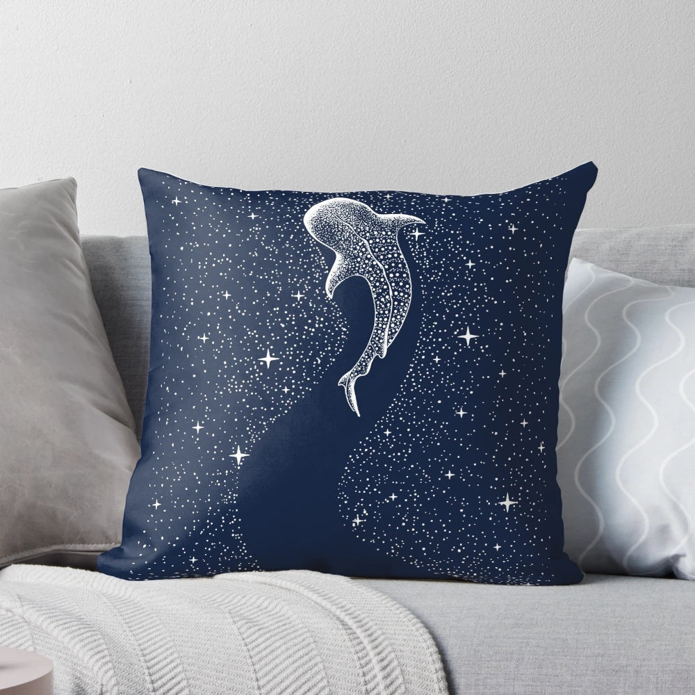 A photo of a pillow with a surreal design featuring a whale shark in a starry, cosmic seascape.