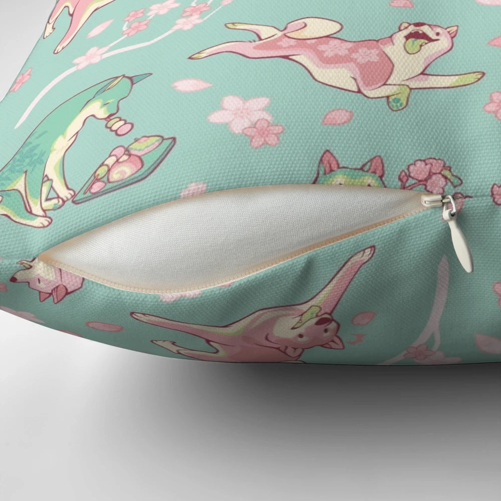 A beautiful mint green pillow featuring a design of a shiba inu dog surrounded by sakura blossoms and matcha leaves.