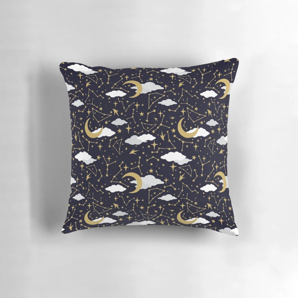 A decorative pillow featuring a celestial design of shimmering stars and moons in gold and white.