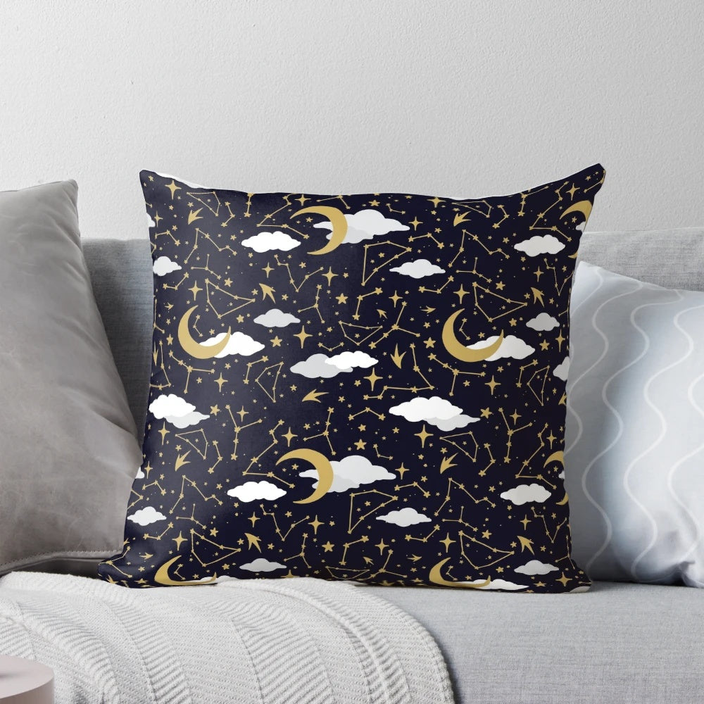 A decorative pillow featuring a celestial design of shimmering stars and moons in gold and white.