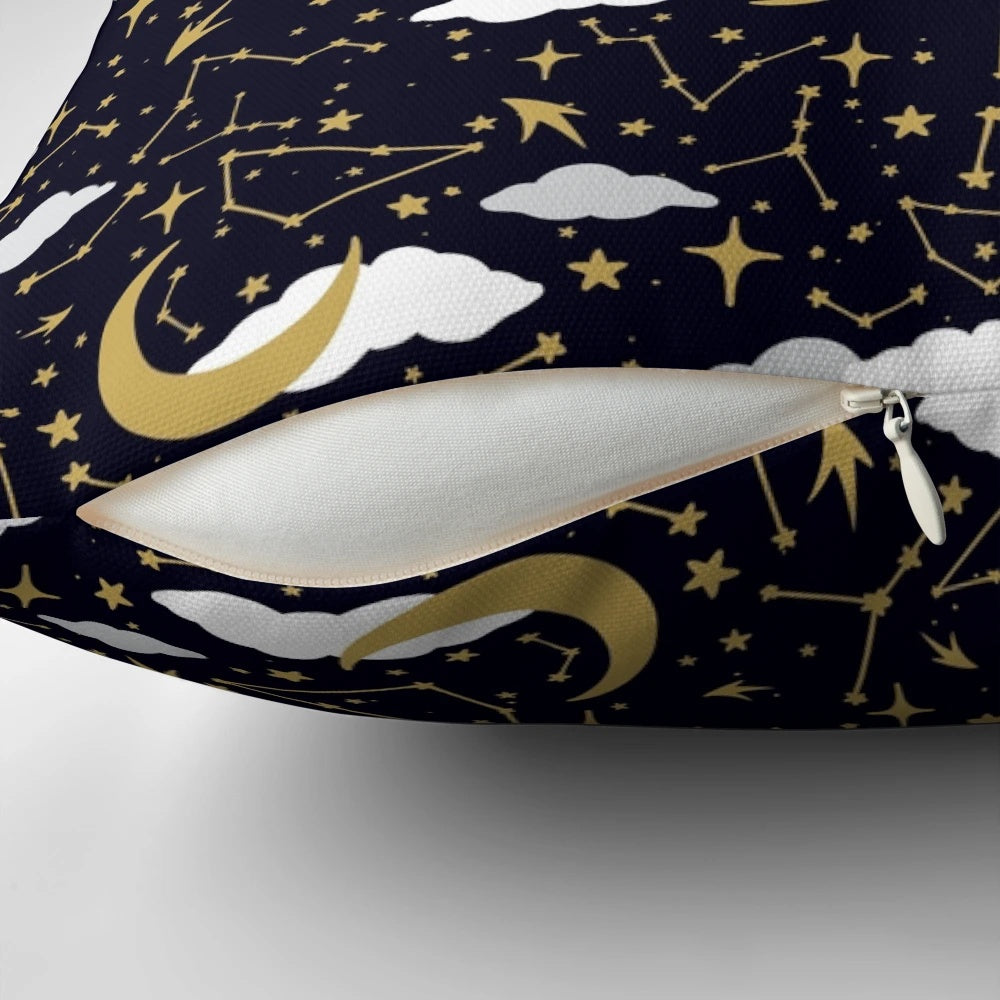 A decorative pillow featuring a celestial design of shimmering stars and moons in gold and white.