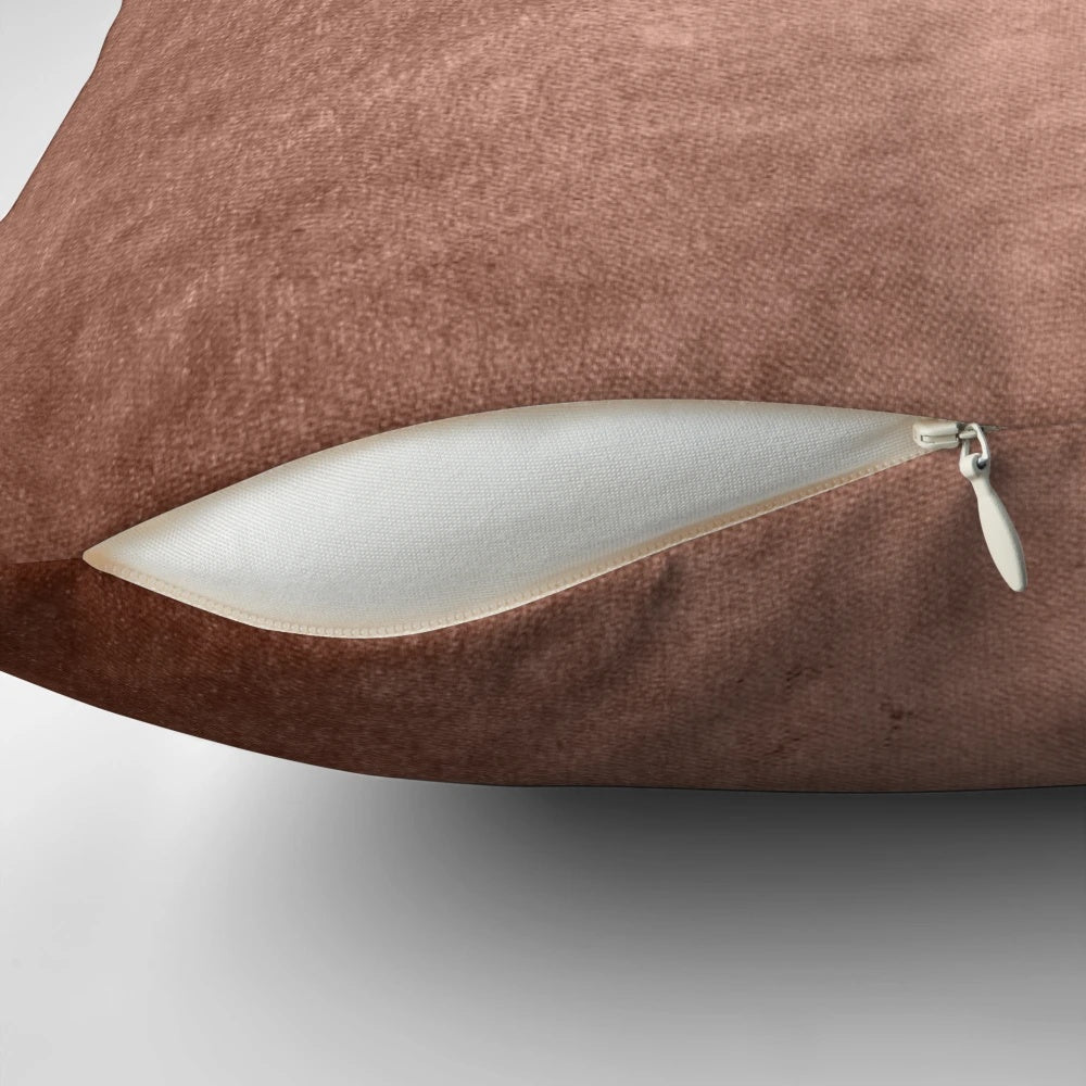 Closeup of a shiny, faux metallic copper textured pillow for home decor