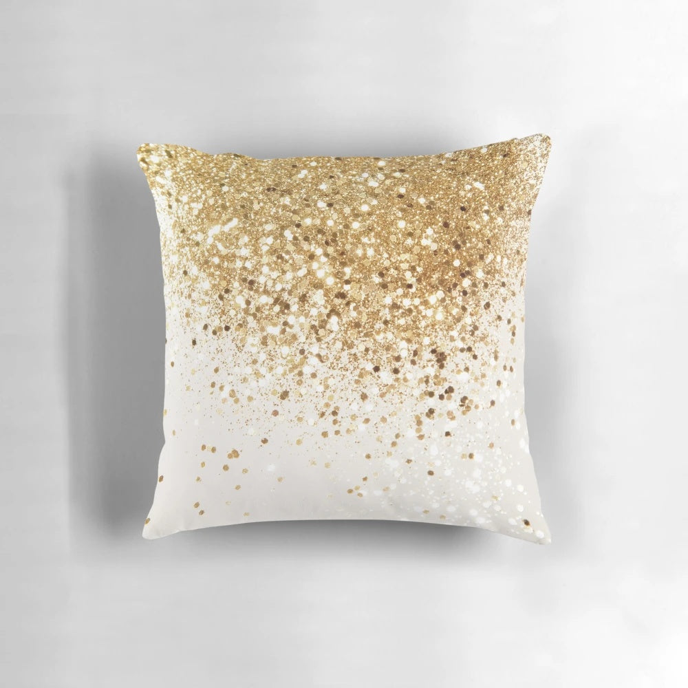 Close-up image of a decorative throw pillow with a glittery gold surface