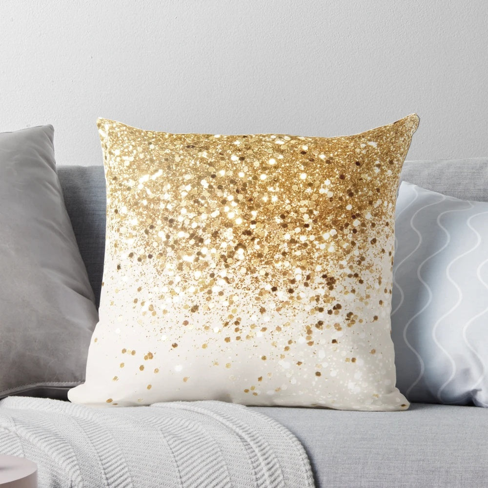 Close-up image of a decorative throw pillow with a glittery gold surface