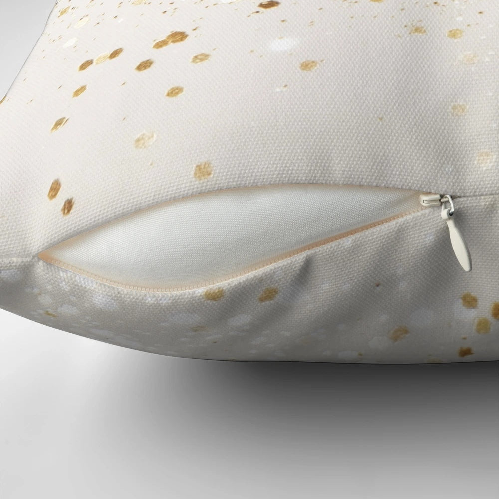 Close-up image of a decorative throw pillow with a glittery gold surface