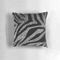 Photograph of a throw pillow with a silver glitter zebra print design.
