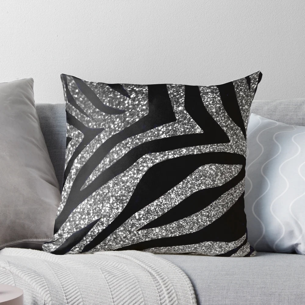 Photograph of a throw pillow with a silver glitter zebra print design.