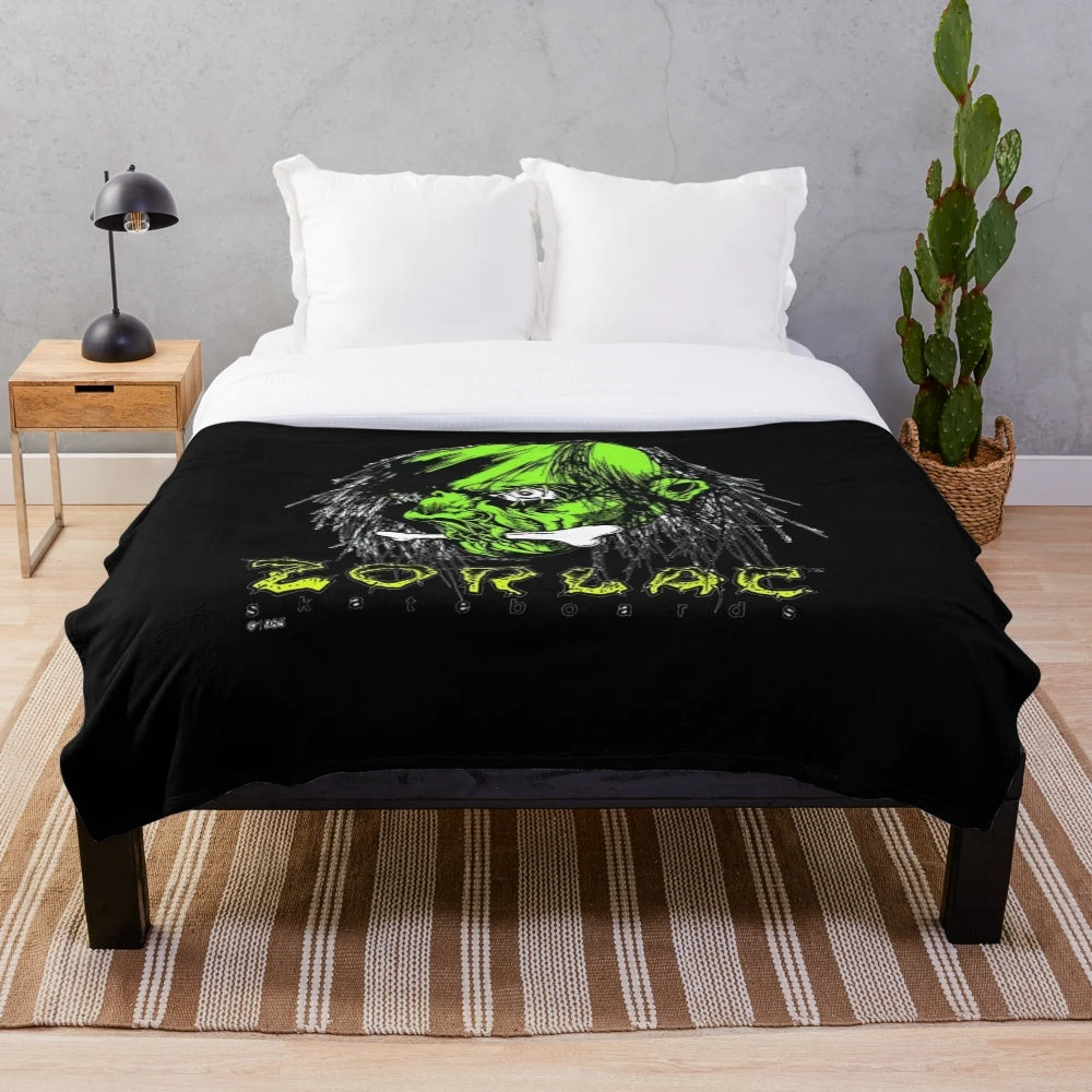 Plush blanket featuring a shrunken head design inspired by the work of Pushead and Zorlac skateboards