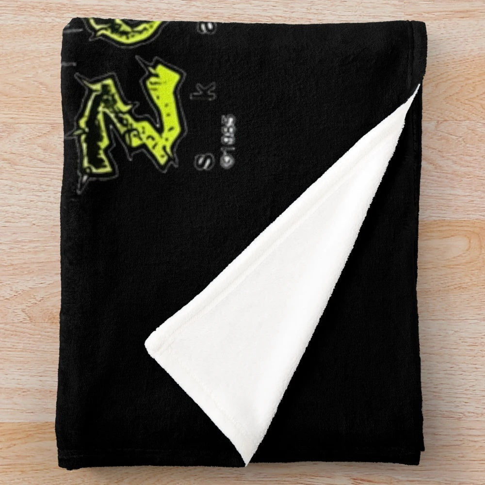 Plush blanket featuring a shrunken head design inspired by the work of Pushead and Zorlac skateboards