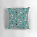 A green decorative pillow featuring various sighthound dog breeds such as greyhounds, whippets, and Italian greyhounds.