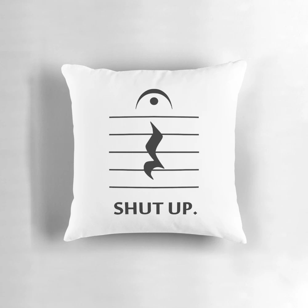 A decorative pillow featuring musical notation and the text "Shut Up