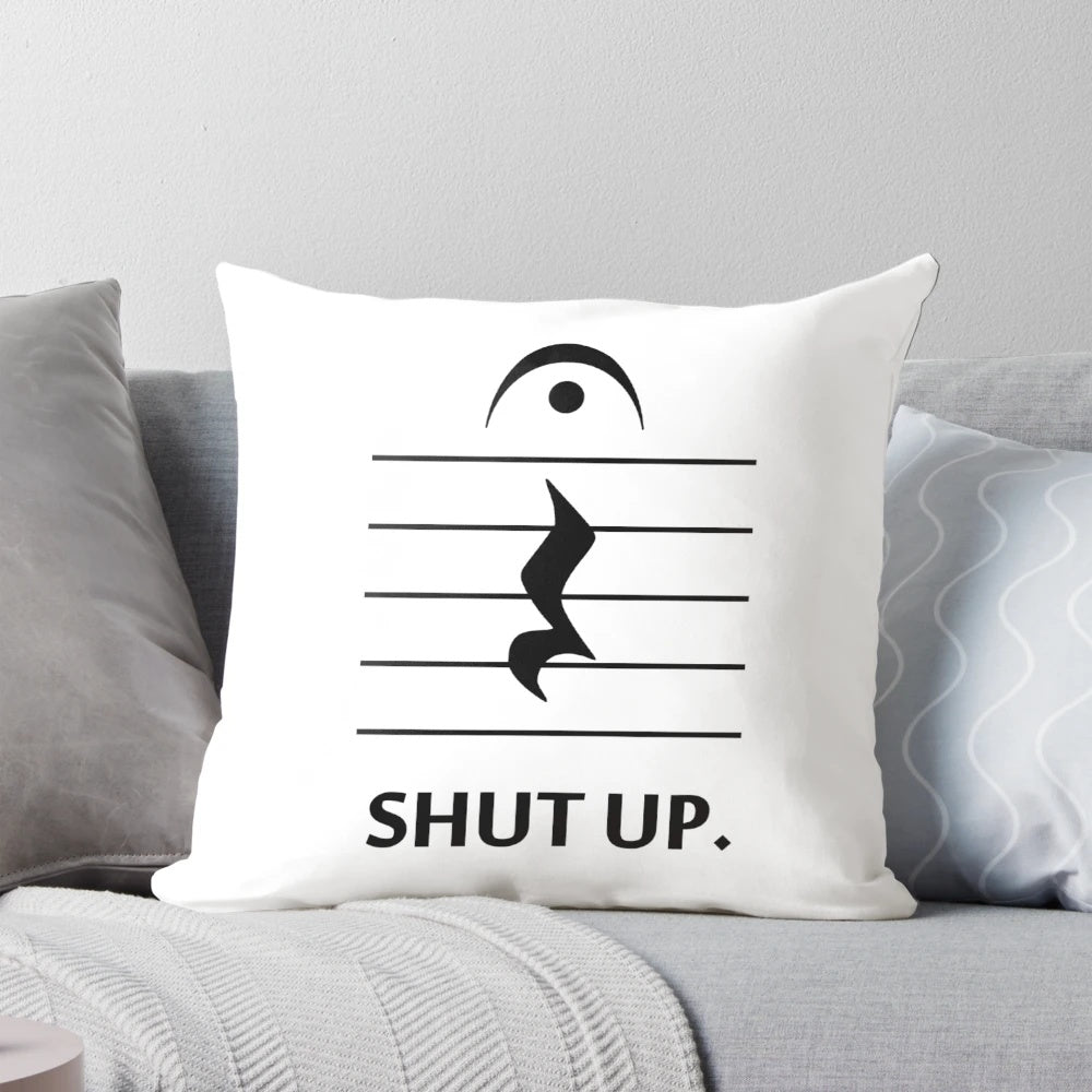A decorative pillow featuring musical notation and the text "Shut Up