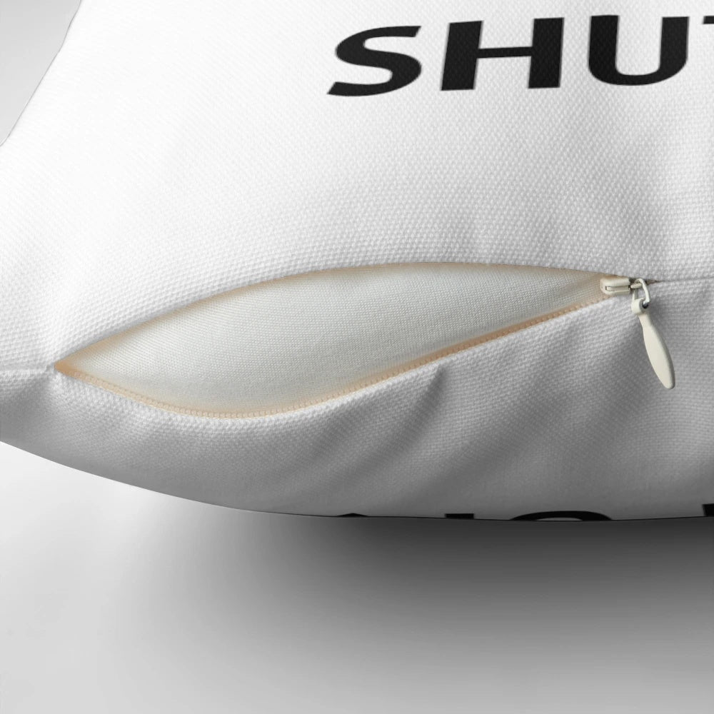 A decorative pillow featuring musical notation and the text "Shut Up