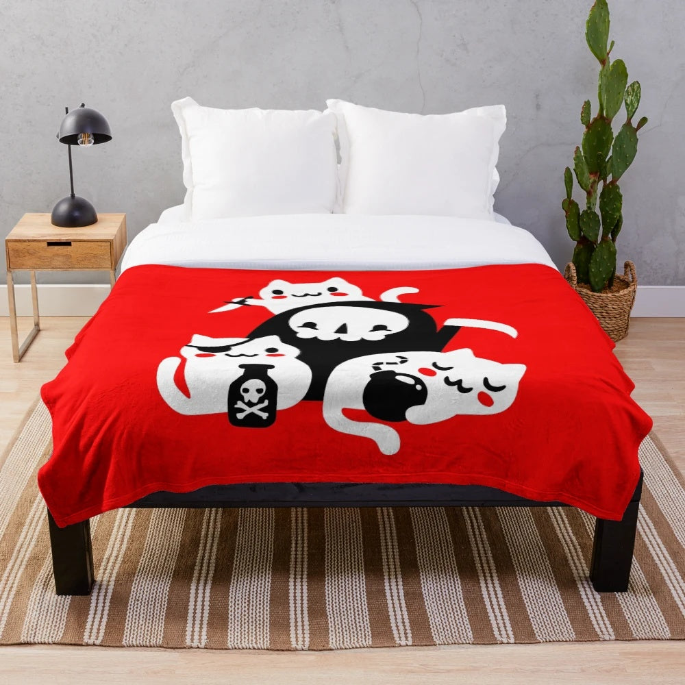 Plush blanket featuring kittens and skulls in a dark, gothic design