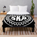 Plush blanket featuring the iconic ska music symbol or logo
