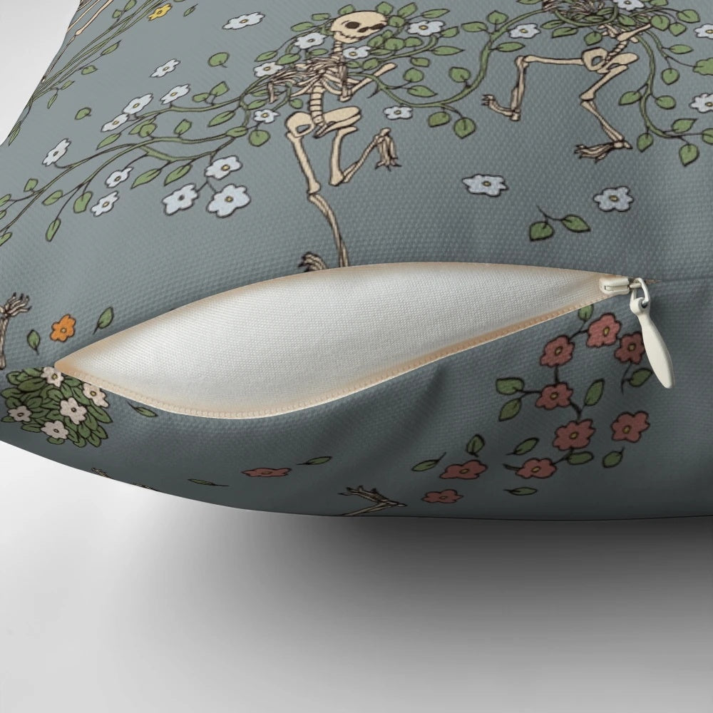 Decorative throw pillow featuring a skeleton design with floral garlands