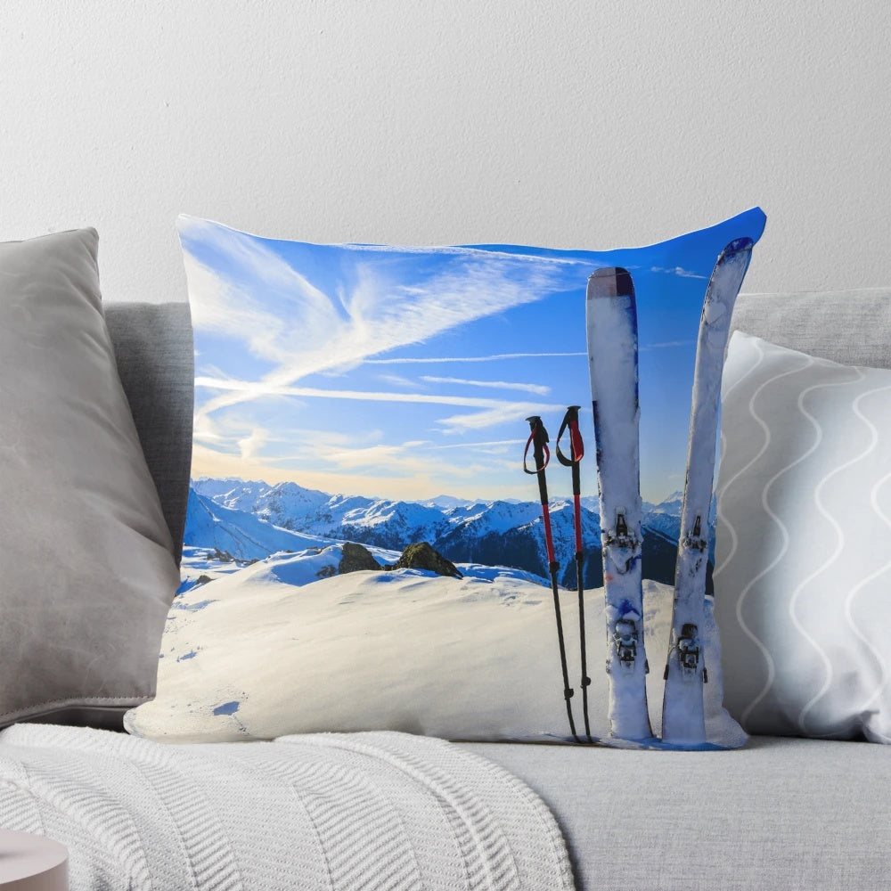 Ski mountain scene printed on a decorative pillow, featuring snowy mountains and skiing imagery.