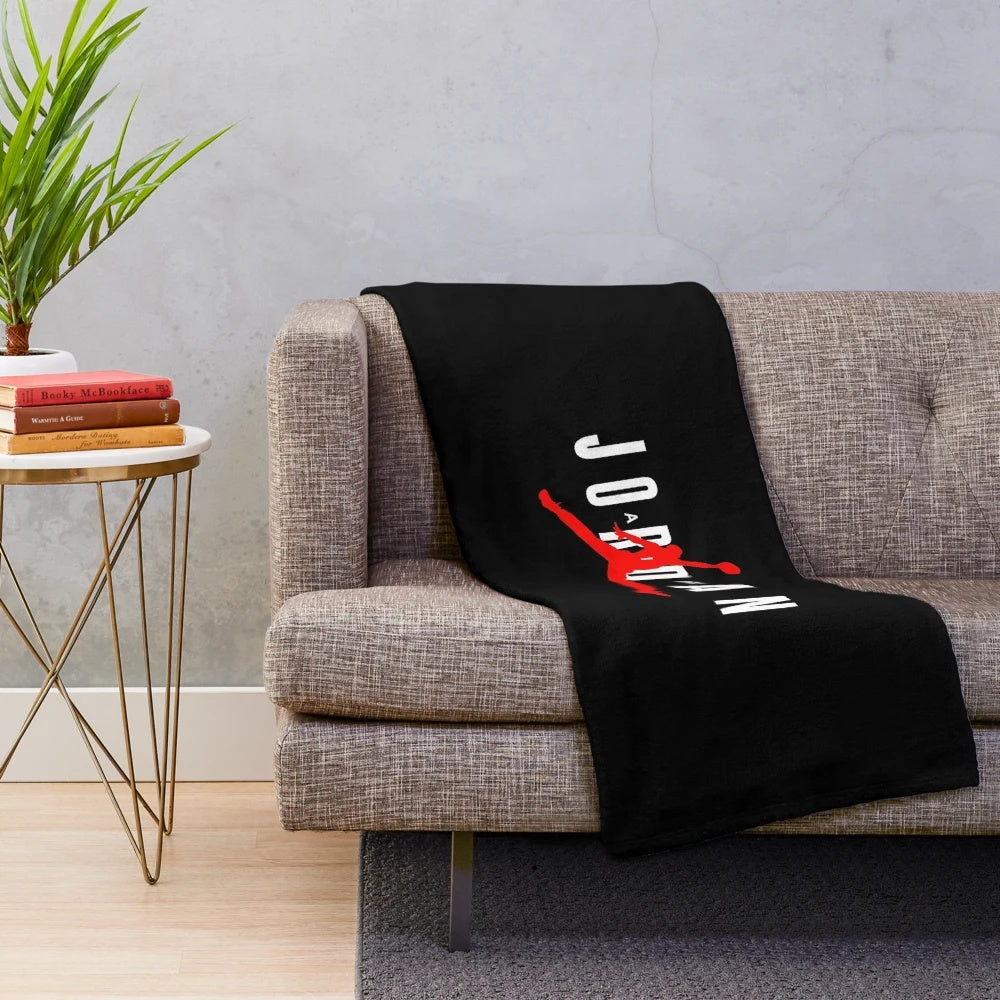 Sports-themed plush blanket featuring a jumping basketball player silhouette