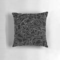 A decorative black and white pillow featuring a stylized race track design, perfect for motorsports enthusiasts.