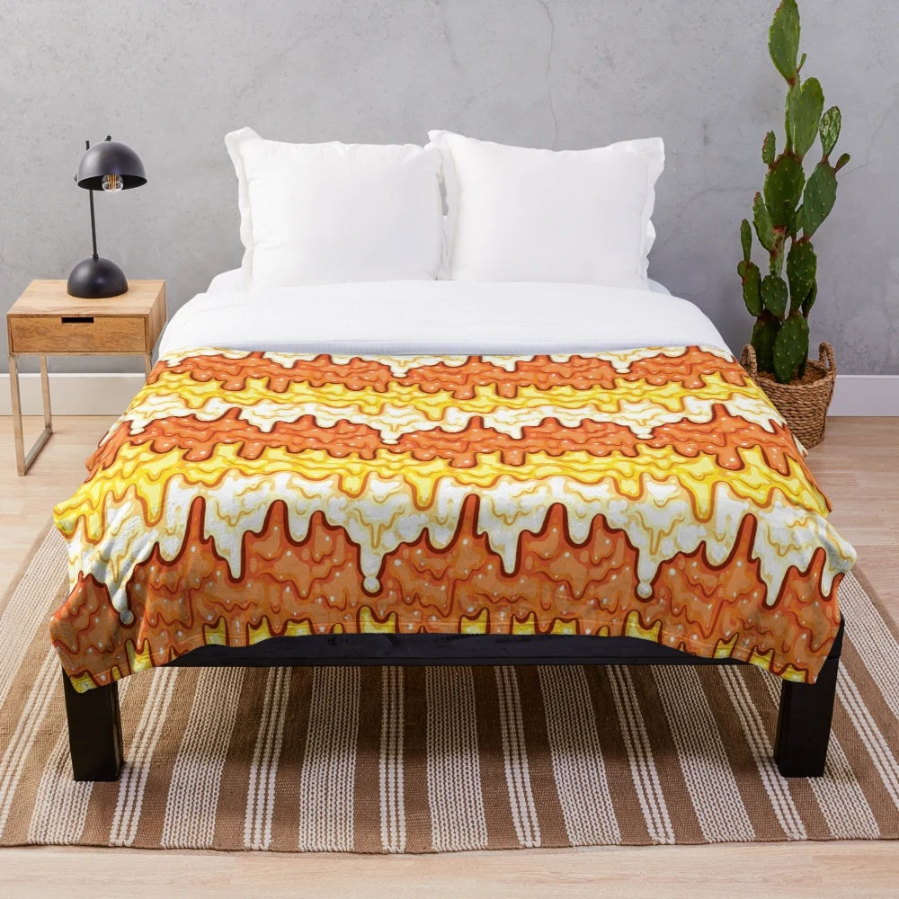 Slime-patterned plush blanket featuring a repeating candy corn motif