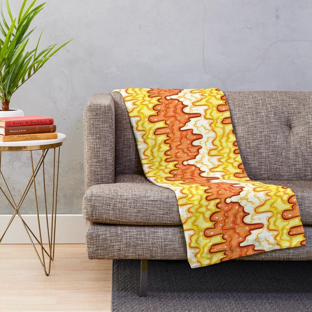 Slime-patterned plush blanket featuring a repeating candy corn motif