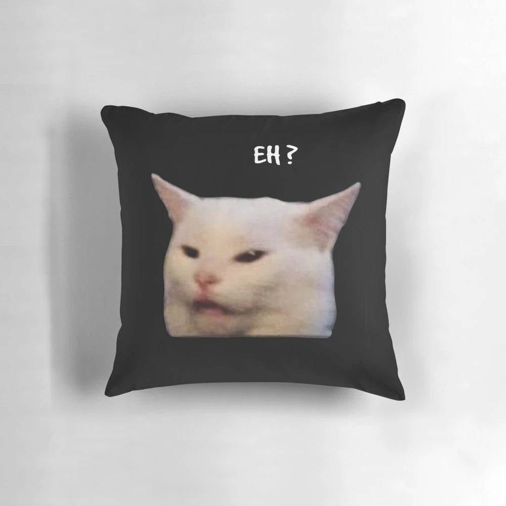 Smudge the cat sitting on a table, a popular and funny cat meme image printed on a soft pillow