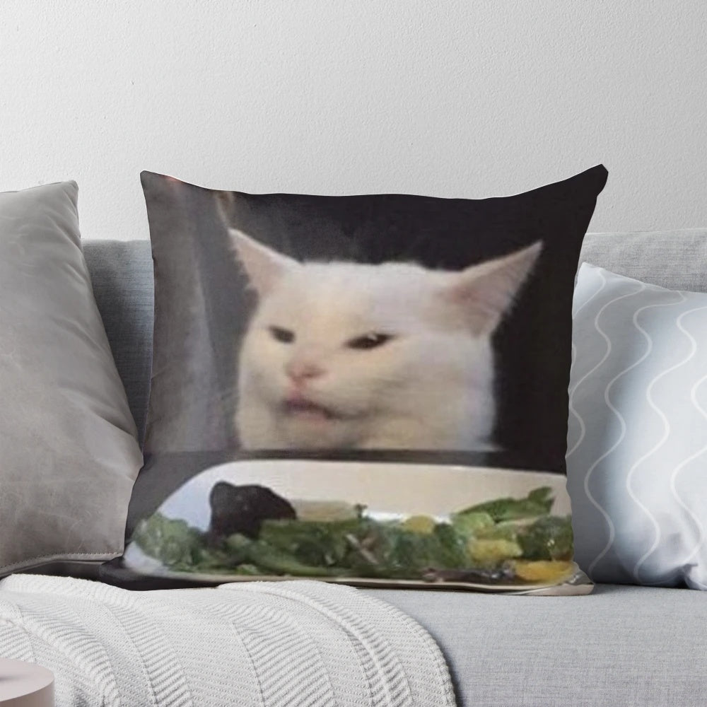 Smudge the cat, a popular meme featuring a confused and angry-looking white cat, printed on a plush throw pillow.