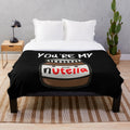 A soft and cozy plush blanket with a Nutella-inspired design