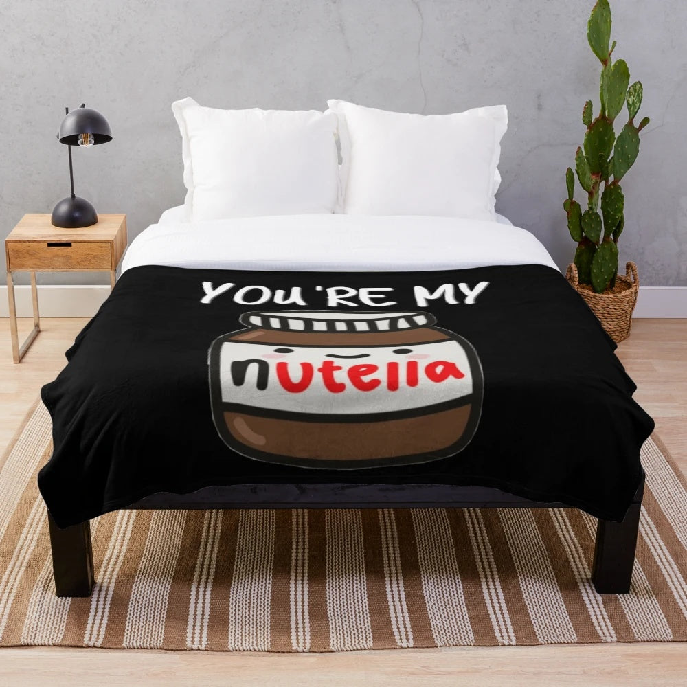 A soft and cozy plush blanket with a Nutella-inspired design