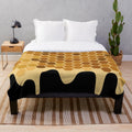 Honey-colored plush blanket with an abstract design