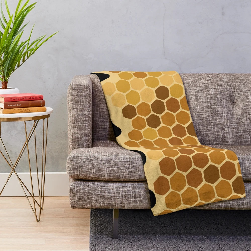 Honey-colored plush blanket with an abstract design