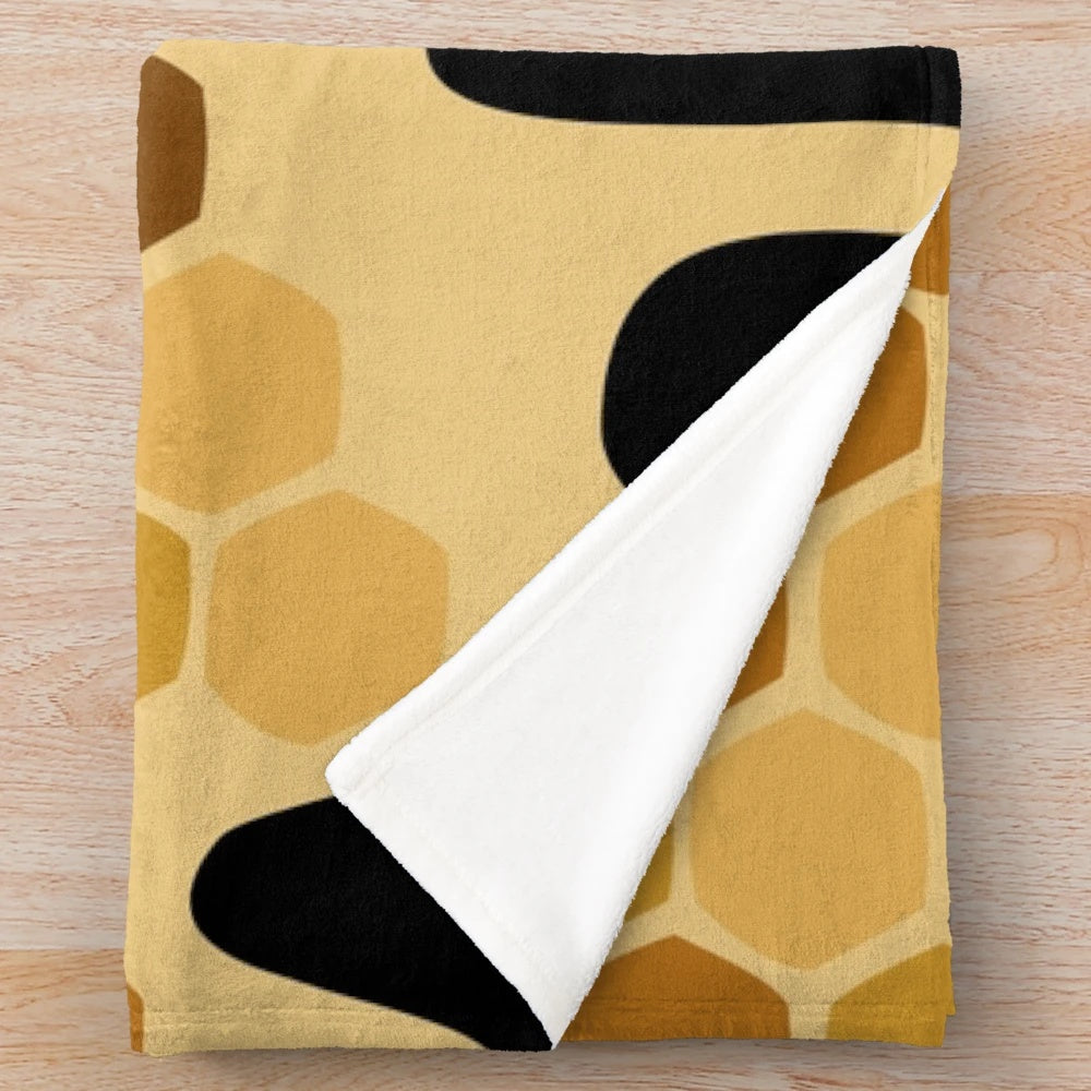 Honey-colored plush blanket with an abstract design
