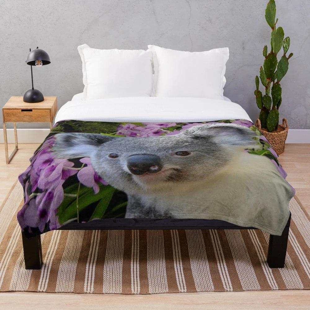 Soft and cozy plush blanket featuring adorable koalas and Cooktown orchids