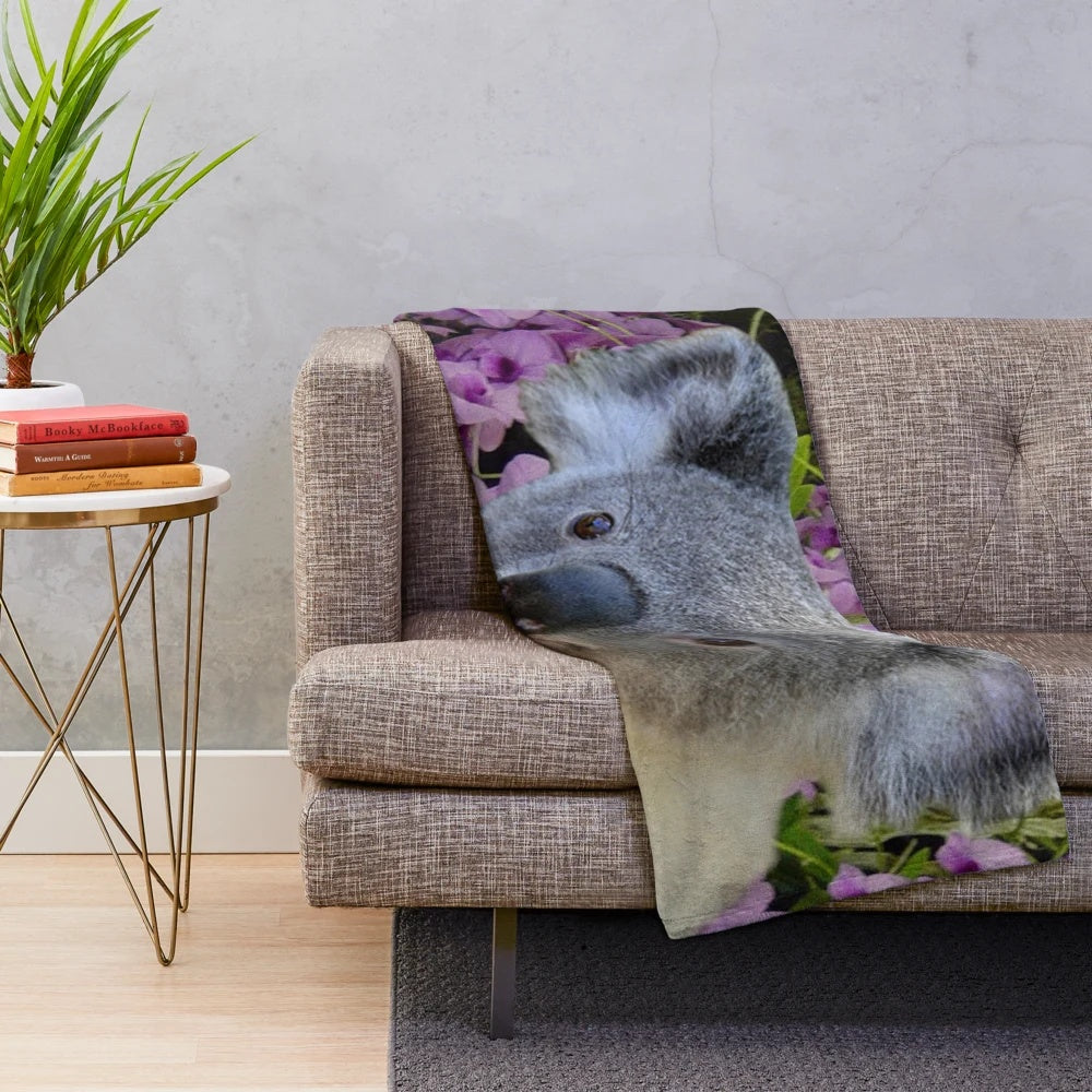 Soft and cozy plush blanket featuring adorable koalas and Cooktown orchids