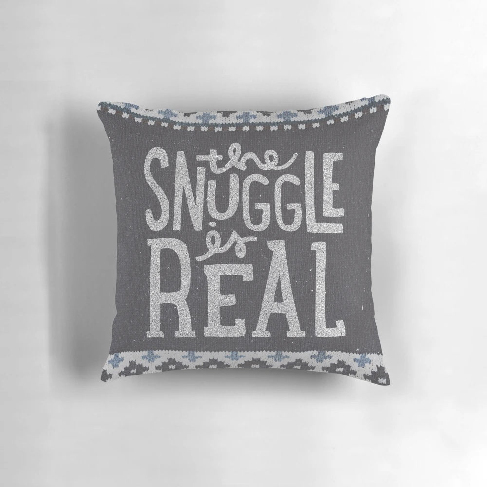 A cozy and soft pillow with a "The Snuggle is Real" lettering design