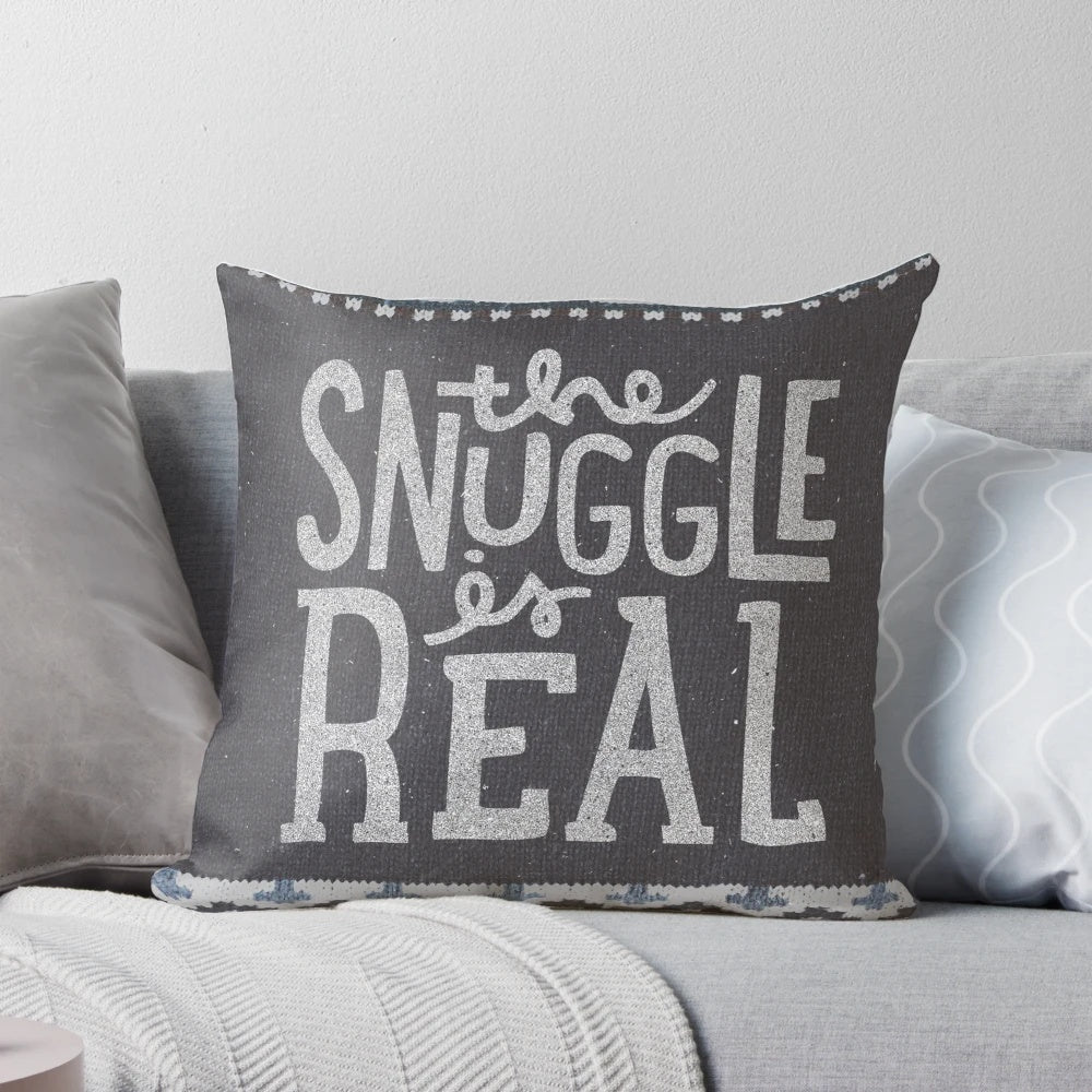 A cozy and soft pillow with a "The Snuggle is Real" lettering design