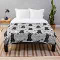 Black and white miniature schnauzer dog on a soft, plush blanket