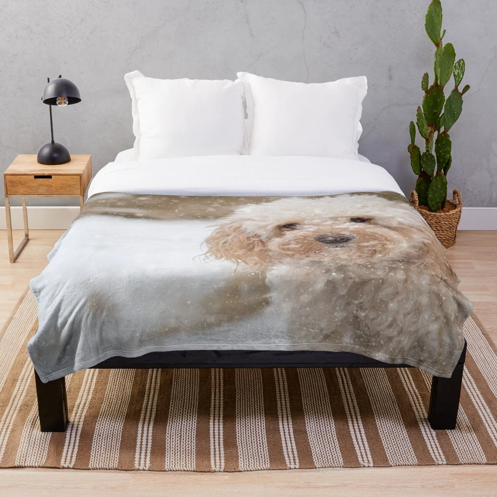 A fluffy plush blanket featuring an adorable cockapoo dog in the snow