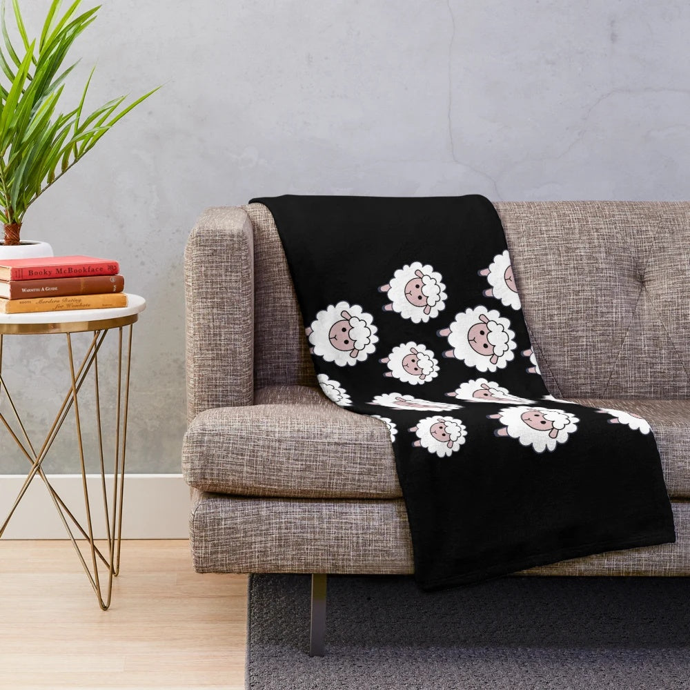 A plush blanket featuring a herd of cute, cartoon sheep