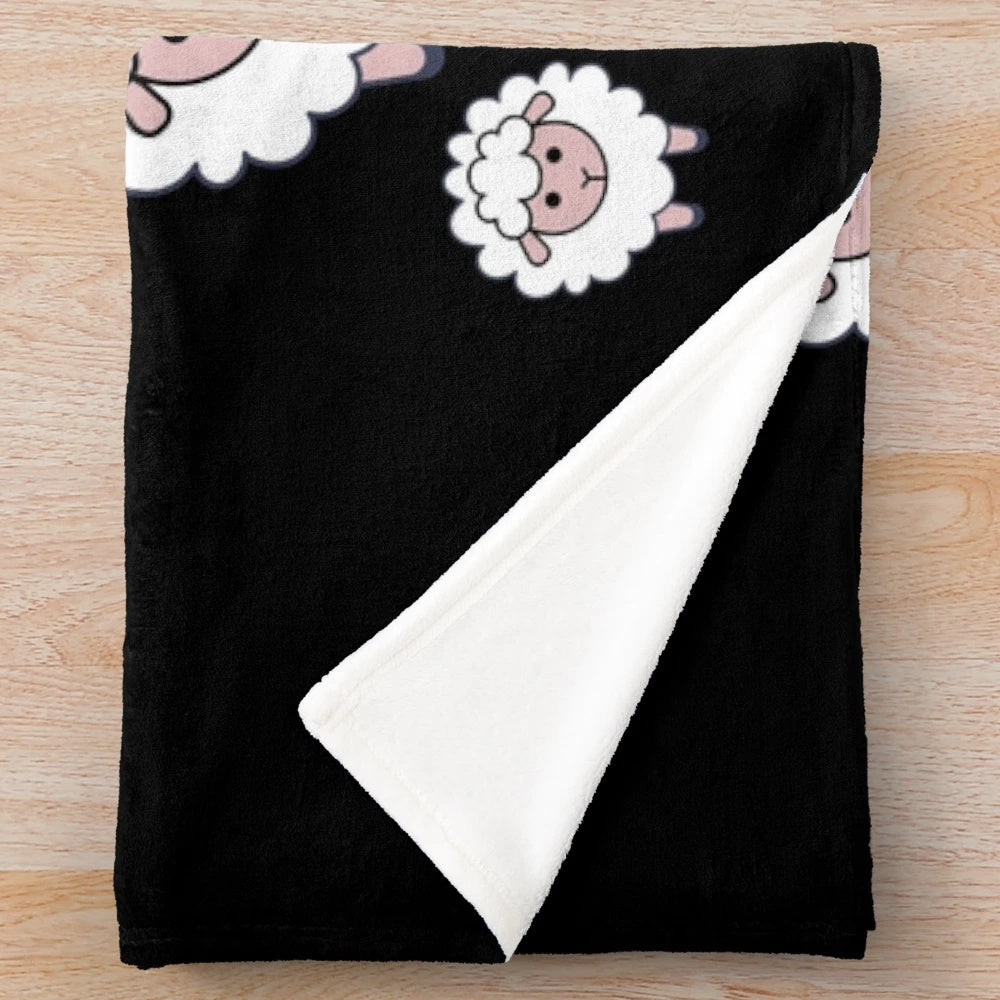 A plush blanket featuring a herd of cute, cartoon sheep