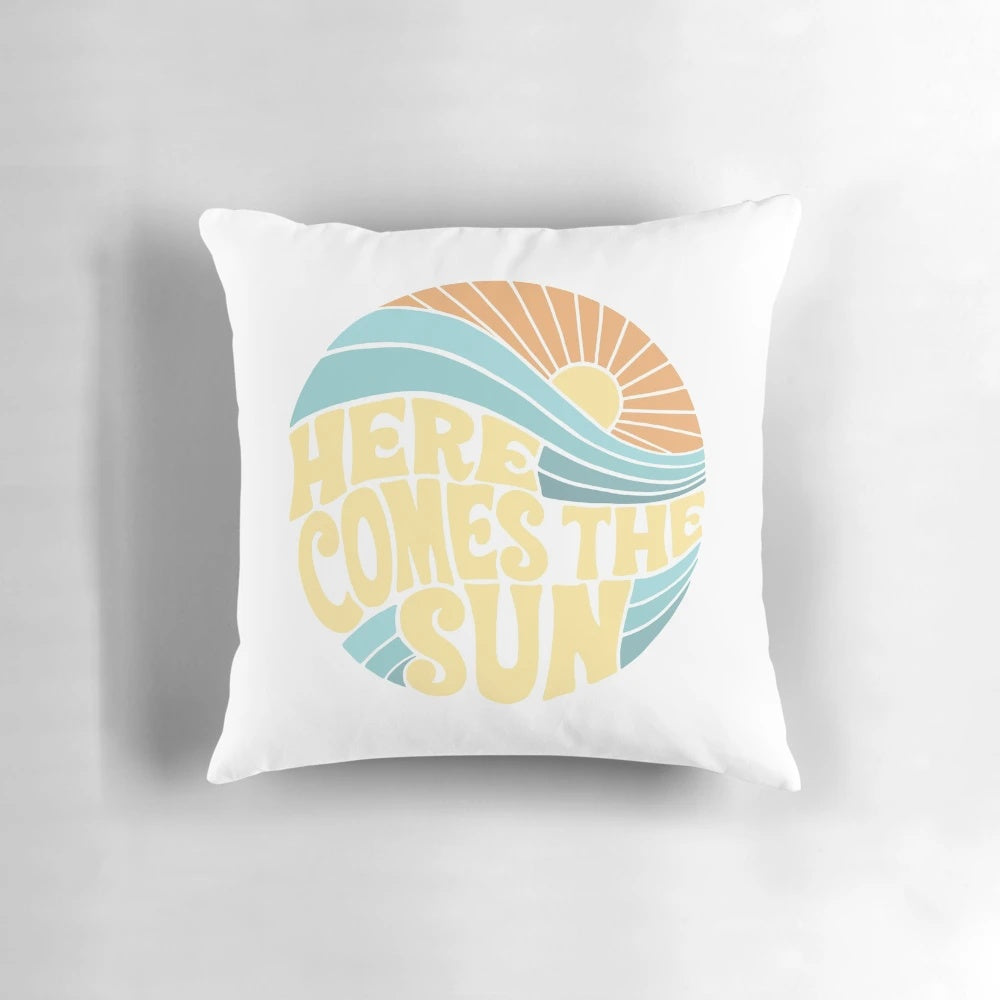 Colorful and vibrant 'Here Comes the Sun' pillow featuring sunshine, ocean, and summer vibes